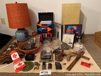 Overview of all items including lamp, vintage cars, glass vases, shells, feathers, baskets, and framed art