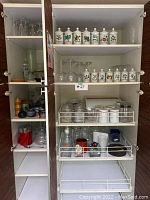 Cabinet with white ceramic herb canisters, glassware, and kitchen items