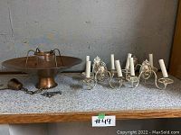Photo showing entire lot of a copper chandelier and four vintage wall sconces on shelf