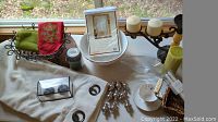 Overview of collected home decor items on a table near window.