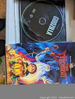 DVD disc for Godzilla and The Hobbit cover art in case