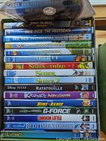 Stacked DVDs showing titles from Jimmy Neutron to Cats and Dogs