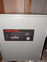 Front view of Fire Fyter fire safe showing combination lock dial, handle, and key lock on control panel