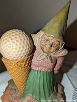 Close-up image of Babe gnome holding large ice cream cone topped with golf ball, showing detailed coloring and facial expression.
