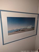 Art print featuring a British Columbia beach scene with sailboats, framed in blue.