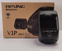 Photo of Rexing V1P Gen 3 dash cam with 2.4 inch screen displayed alongside its original branded box illustrating the model and WiFi feature.