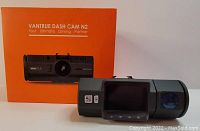Photo of the Vantrue Dash Cam N2 device alongside its original orange box labeled "Vantrue Dash Cam N2 Your Ultimate Driving Partner".