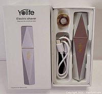 Photo showing the Yolife electric shaver in its box with the device, head attachment, and charging cable visible.
