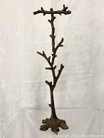 Front view of the metal jewelry holder tree against a white backdrop.