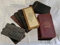 Lot of twelve diary and date books stacked and shown from above and side views