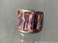 Front view of the sterling silver ring with three light pink rectangular stones, showing ring face and stones.