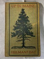 Front cover of 'Up In Maine' with beige cloth, green pine tree illustration, and orange text.