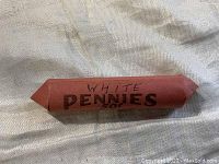 Roll of 50 1943 steel zinc pennies wrapped in red paper labeled 'WHITE PENNIES 50c'