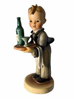 Front angle view showing the waiter figurine holding a tray with a bottle and glass