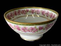 Side view of the bowl showing pink floral pattern and gold trim on the rim and base.