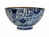 Side view of vintage Japanese ceramic rice bowl showing detailed blue stylized cat faces pattern around bowl.
