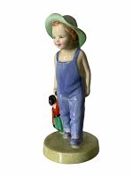 Front angle of porcelain figurine of boy wearing green hat and blue overalls holding doll