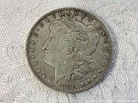 Obverse side of 1890 Morgan Silver Dollar showing Lady Liberty's profile with inscription and date.