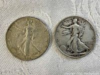 Obverse side of the 1936 and 1946 Walking Liberty half dollar coins showing Lady Liberty design and date.