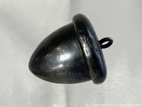 Close-up of the acorn pendant showing its shape and surface texture