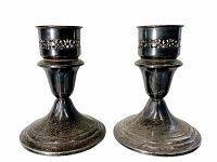Pair of Gorham sterling silver weighted candle holders with dark patina and pierced decorative band, photographed on white background.