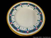 Top view of a Mintons dinner plate showing the floral decoration with roses and gold rim