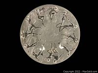 Top-down view of a single plate showing the twelve dancing nymph relief figures and central swirl motif