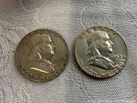 Obverse side of two 1952 Franklin half dollar silver coins showing Benjamin Franklin's profile and inscriptions 'LIBERTY', 'IN GOD WE TRUST', and year '1952'.
