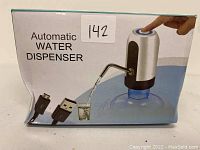 Automatic water dispenser in packaging, showing the device, USB cable and water pouring from spout.