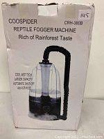 Box displaying Coospider CRH-380B reptile fogger machine with product details such as cool mist technology, larger capacity, automatic shut-off, and up to 6.5 ft hose.
