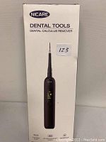 Front views of the Nicare dental calculus remover on its packaging showing the device and key features such as 5 settings mode, LED high-definition screen, and waterproof capability.