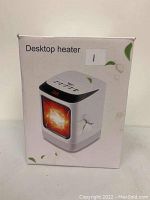 Front side of the heater box showing image of the white desktop heater with digital display and heating element visual.