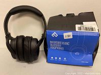 Black Infurture H1 ANC Bluetooth over-ear headphones placed beside the original blue and black box which shows model number H1ANC1 and the brand.