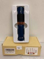 Blue Joyo pet nail grinder in white plastic tray and yellow cardboard box with barcode and label visible.