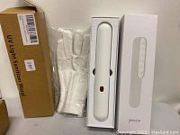 Purpleglow UV Light Sanitizer Wand in its box, box labeled 'UV Light Sanitizer Wand,' with packaged white cotton gloves beside it.
