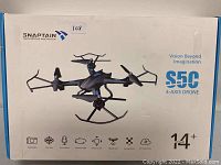 Photo of Snaptain S5C 4-axis drone retail box showing drone image, model, and key features.