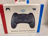 Boxed wireless controller for Nintendo Switch shown on front of package with red, white, and blue border.