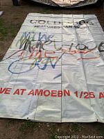 Full view of large white vinyl tarp promoting Cold Cuts featuring Ian Rubb with colorful graffiti-style writing
