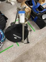 Upper section of one tripod showing pan and tilt head with adjustment knobs and mounting plate.