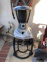 Full view of the Coleman outdoor propane mosquito repeller showing the 39-inch tall unit with attached wheels and handle.