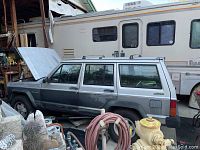 Left side profile showing entire vehicle body and hood open