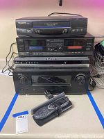 Full stack of all four devices with remote control in front