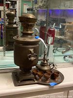 Full view of samovar, teapot, four cups, and tray showing overall lot