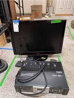 Samsung flat-screen TV shown with stand and Monster Power home theatre power center placed in front on carpeted floor in indoor environment.