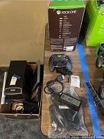 Front view showing Xbox One Titanfall retail box alongside controllers in cardboard container