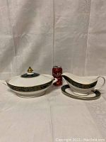 Photo showing the covered vegetable dish with its lid and the gravy boat with spill dish next to a soda can for size comparison.