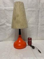 Full view of MCM table lamp with original shade beside a soda can for size reference