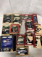 Photo of full lot showing 12 unopened boxed Hallmark Star Trek ornaments including ships and character figures