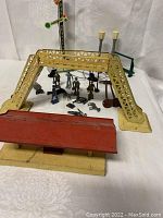 Overview photo showing yellow truss bridge, red station platform, railroad signal, dual street lamps, and various figurines.