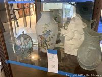 Glass cabinet shelf with Birds of Summer vase, two Royal Doulton fish sculptures, decorative pitcher